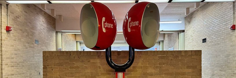 Pay Phones Photo of two red pay phones in one of the hallways.